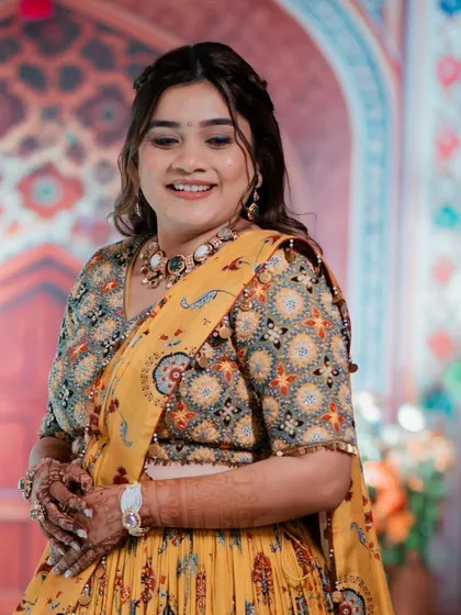 A full view of Pooja's stunning Haldi look. The traditional yellow lehenga is so vibrant, and her fresh makeup look complements it perfectly.