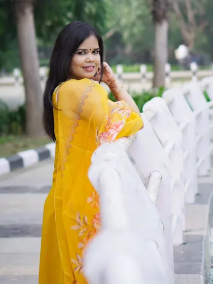 A classic over-the-shoulder pose during an outdoor portfolio session. The lighting is soft and natural.