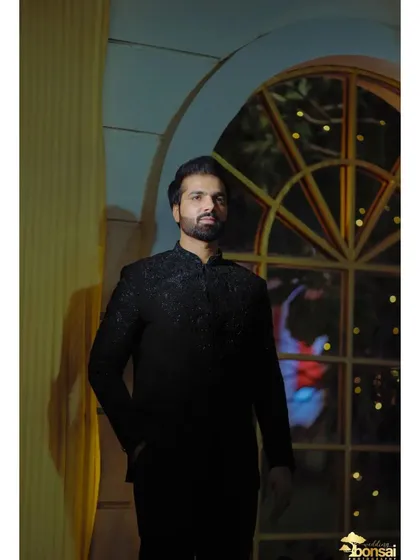 A portrait of the groom in a stylish black bandhgala, perfect for a reception or sangeet night.