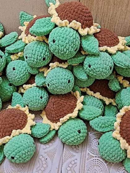A big pile of my sunflower turtle plushies. The shell is designed to look like a sunflower, combining two of nature's cheeriest things.