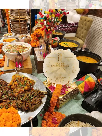 A colourful and festive buffet table decorated with marigold garlands. This setup is perfect for traditional Indian celebrations like Mehendi or Haldi.