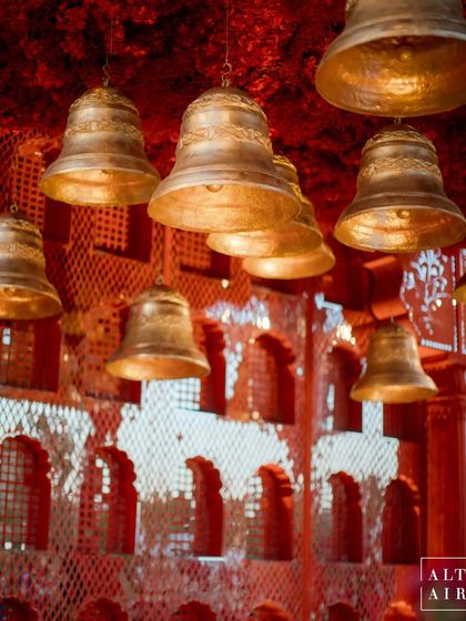 A close-up of the hanging brass bells within the 'Kaanch Bagh' mandap. These traditional elements added a beautiful auditory and visual layer to the design, echoing with symbolism and heritage.