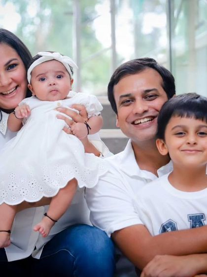 A classic family portrait on the steps, with everyone smiling. A beautiful memory of this stage of their lives.