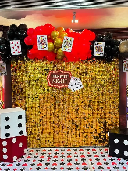 For a fun-filled adult party, we designed this exciting Teen Patti and casino night theme. The setup features a glittering gold sequin wall, oversized playing card props, and giant dice, setting the perfect mood for a night of games and fun.