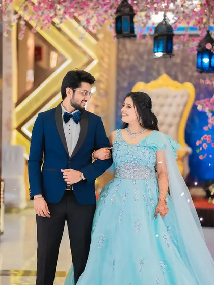 A classic portrait of Shraddha and Vivek at their engagement reception. This shot captures the couple looking elegant against the backdrop of their grand celebration.