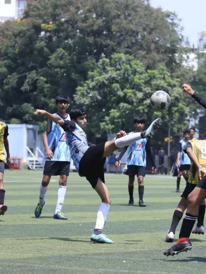 A player attempts a volley, showcasing advanced technique and the confidence to take on difficult shots during a match.
