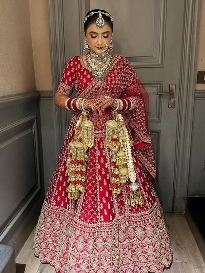 A full-length shot of my bride in her classic red lehenga. She looks so poised and elegant.