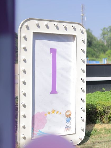 A light-up marquee sign displaying the number '1', perfect for a first birthday carnival celebration. The simple design allows the milestone to be the star of the photo.