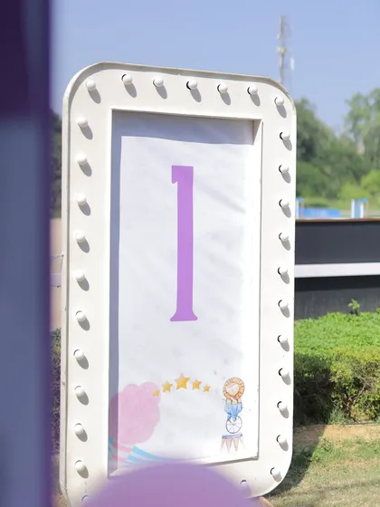 A light-up marquee sign displaying the number '1', perfect for a first birthday carnival celebration. The simple design allows the milestone to be the star of the photo.