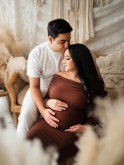 A tender forehead kiss in our warm, earthy-toned setup. This is such a sweet and intimate moment.