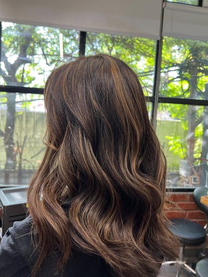 Another angle of this beautiful brunette balayage, showing the seamless blend from the natural root color to the lighter ends.