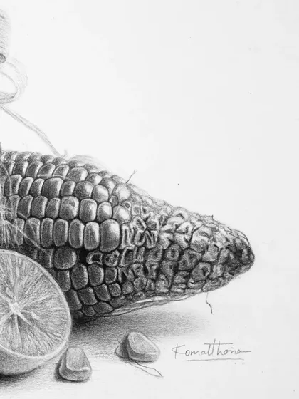 A close-up of the corn and lemon, showing the texture of the kernels and the juicy pulp of the lemon.