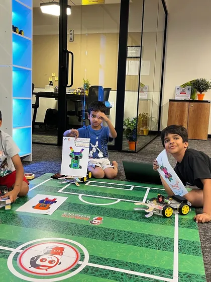 The robot soccer competition is always a highlight! This picture captures the excitement as students get their custom-built robots ready for a friendly match, combining design, strategy, and teamwork.