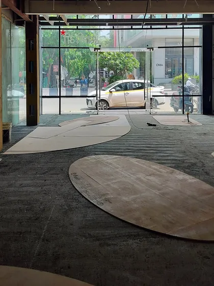 An in-progress shot from the Entisi site, showing the plywood templates for the custom flooring design. This step is crucial for ensuring our intricate patterns are executed perfectly on the ground.
