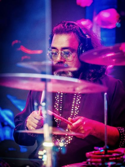 Our drummer, focused and precise, driving the rhythm of the band forward.