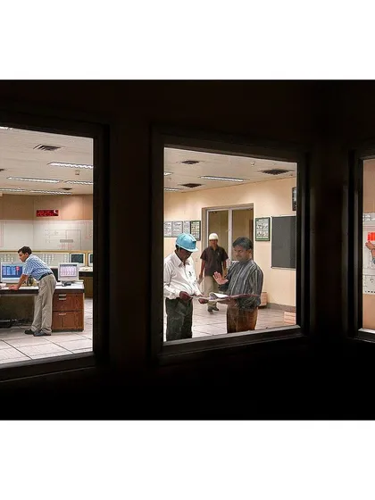 For this industrial shoot, I framed the control room through windows to create a sense of observation. It captures the human element and technical precision involved in the plant's operations for a corporate report.