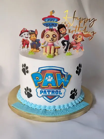 This Paw Patrol cake is ready for a ruff-ruff rescue! It's a non-fondant cake decorated with the Paw Patrol logo, paw prints, and all the main characters, including a fondant Skye topper.