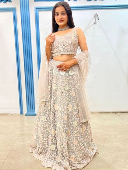 This light grey lehenga with 3D floral applique is a modern and romantic choice for an engagement.