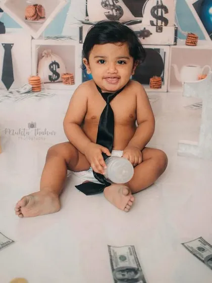 That killer expression says it all. This little businessman is ready to take on the world, one cute photo at a time.