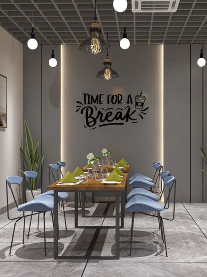 A break area in an office with the words "Time for a Break" on the wall. The industrial-style table and chairs create a casual and inviting atmosphere.