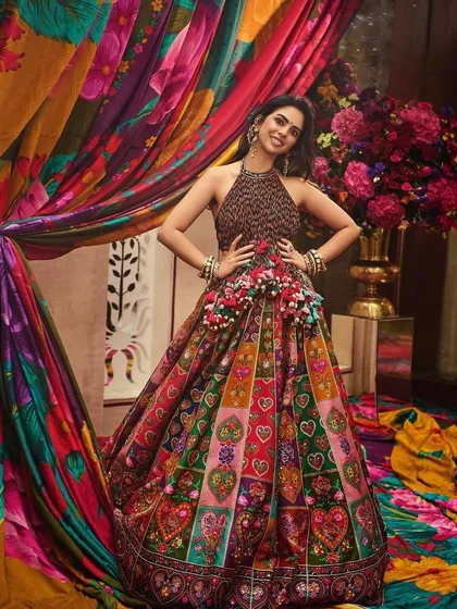A vibrant and playful look for Isha in a multi-colored Torani lehenga. The heart motifs and colorful panels make this a joyful and unique ensemble for festive celebrations.