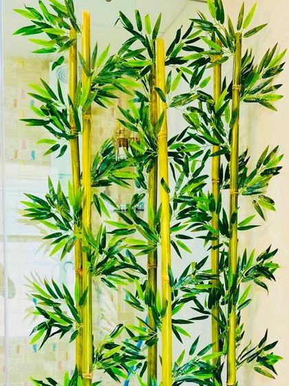 A close-up view of the artificial bamboo stalks. You can see the detail in the nodes and leaves, which makes them nearly indistinguishable from real bamboo plants.