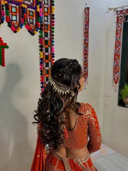 This hairstyle is all about the details, from the delicate braids to the statement accessory.