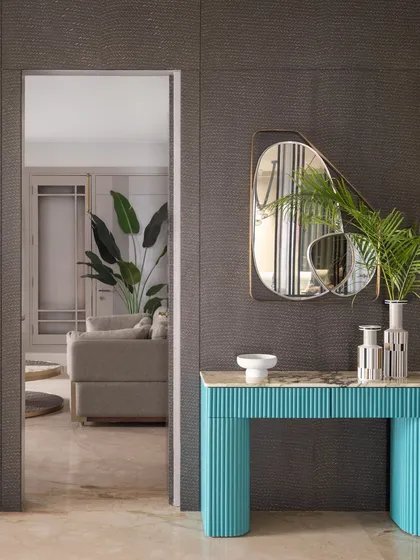 A view of the hidden door when open, revealing the living space beyond. This design element adds an element of surprise and elegance to the entryway.
