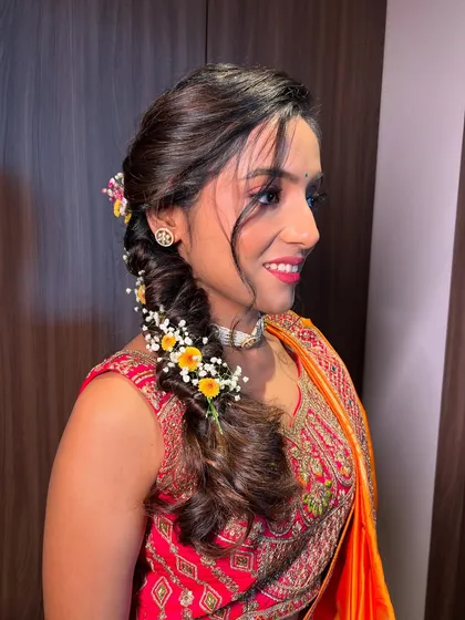 A side profile of the bride, her makeup looking fresh and her smile bright.