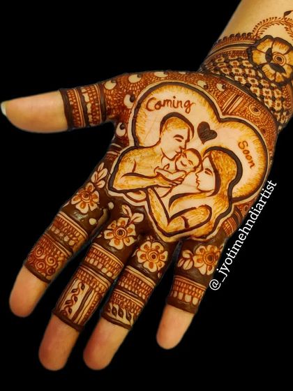 A heartwarming baby shower design with a portrait of the mom, dad, and baby in a heart. The message 'Coming Soon' adds a sweet touch to this celebratory mehndi.