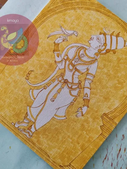 The Meenakshi painting with the yellow base color applied, giving her a golden glow.