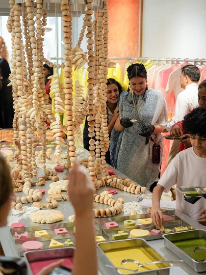 Guests interacting with our unique 'bread and butter' installation at a fashion store launch. The event was designed to be an immersive experience, where food became a form of wearable art.