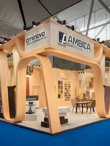 The design for Ambica's 110 sq.m exhibition stall was inspired by the rhythmic motion of a conveyor belt. We translated this industrial aesthetic into an elegant architectural form, with waves rippling around the fascia to suggest dynamic movement.