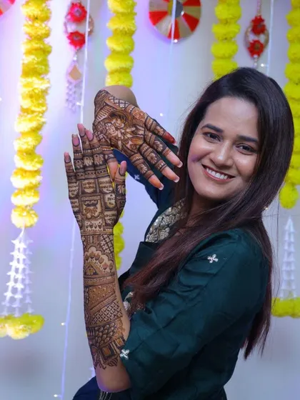 Mehendi is not just a design, it’s an emotion. My lovely bride Falguni, smiling brightly as she shows off her custom bridal mehendi.