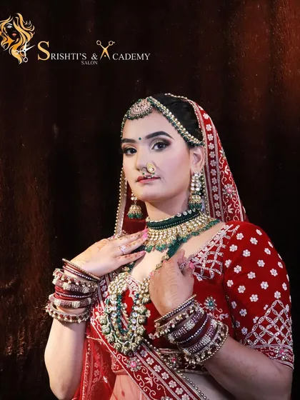 A beautiful shot of a bride in a traditional red lehenga, highlighting the flawless makeup and intricate jewelry.