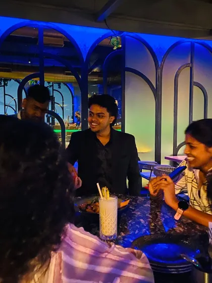 Magic is a conversation. Here I am sharing a laugh with guests at a corporate mixer. My goal with strolling magic is to create a relaxed, engaging atmosphere where your team or clients can connect.