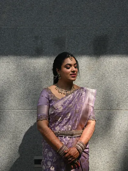 An artistic shot using shadows and light. The bride's features are beautifully highlighted, showing the flawless finish of her makeup.