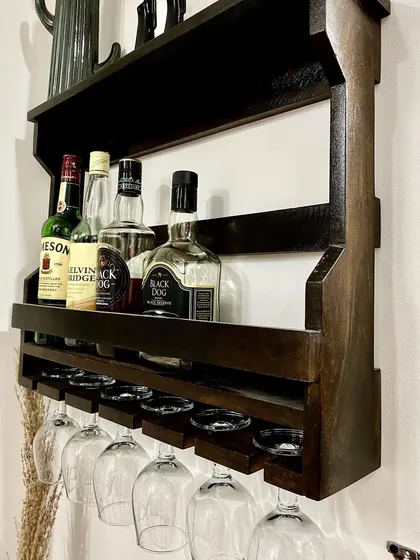 The kitchen area includes this wall-mounted bar rack with wine glasses, ready for you to enjoy a drink.