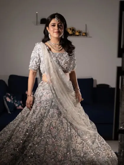 The client looking radiant in her reception outfit. The combination of glamorous hair and makeup makes for a stunning and memorable look.