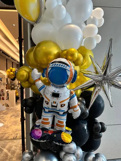 An astronaut balloon sculpture, adding a fun and thematic touch to the space-themed party.