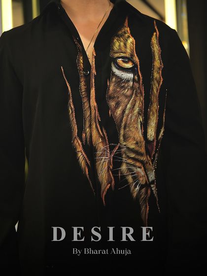 A closer look at the piercing gaze of the tiger. The level of detail in the embroidery and painting makes this shirt a true collector's item.