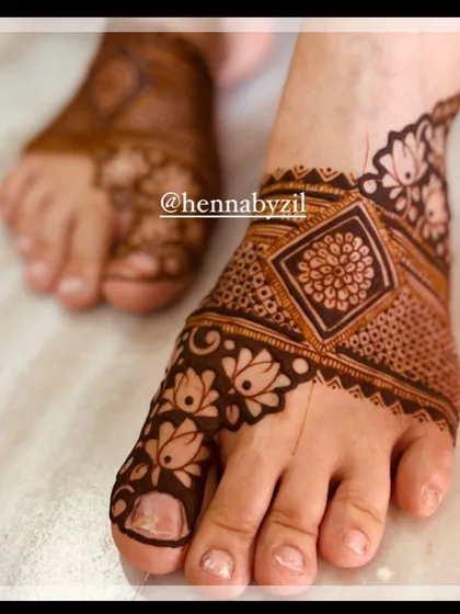 A close-up of a detailed foot design, showing the intricate lotus and geometric patterns.
