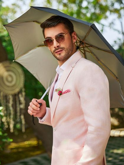 Even on a monsoon day, style doesn't take a backseat. The Rose Quartz linen jacket, with its half-lining, keeps you cool and breezy. The boutonnière and pocket square add a final sartorial touch.