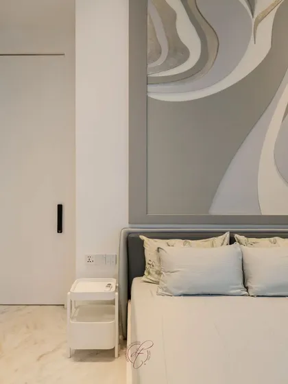 A close-up of the abstract grey headboard, which adds a unique artistic touch to the bedroom. This detail shot highlights our ability to create custom, statement pieces for our clients.