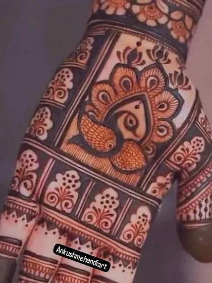 A close-up of a bold peacock motif, using thick lines and shading to create a powerful and artistic look.