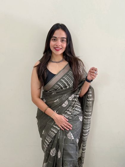 A simple and sweet look against a clean background. The makeup is minimal, with a focus on a radiant complexion and a pop of color on the lips.