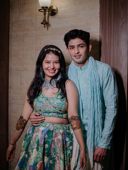 A classic, happy portrait of the couple at their Mehendi ceremony.