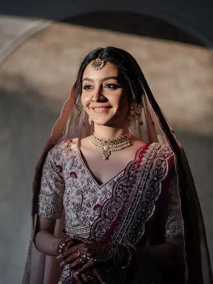 Bathed in sunlight, her makeup looks ethereal and her smile is infectious. This is the essence of a happy, glowing bride.