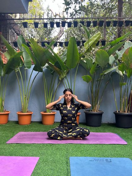 Finding a moment of peace outdoors. A participant practices Bhramari Pranayama (bee breath) in our green space, connecting with nature and calming the mind.