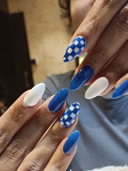A full set of our blue, white, and checkerboard almond nails. This design is perfect for anyone looking for a fun, graphic manicure that stands out.